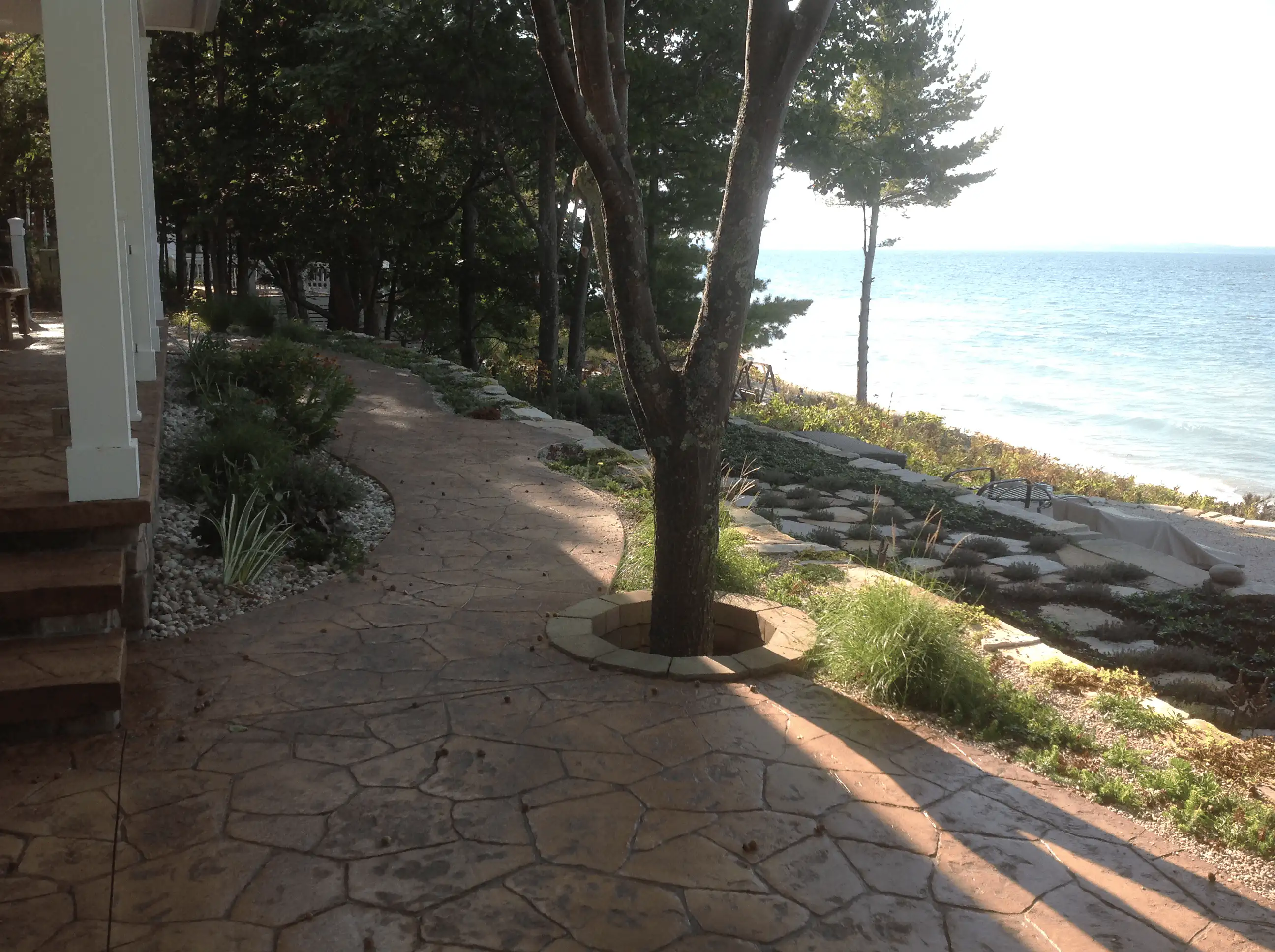 After: finished porch and patio with new plantings, mulch beds, and stone edging.
