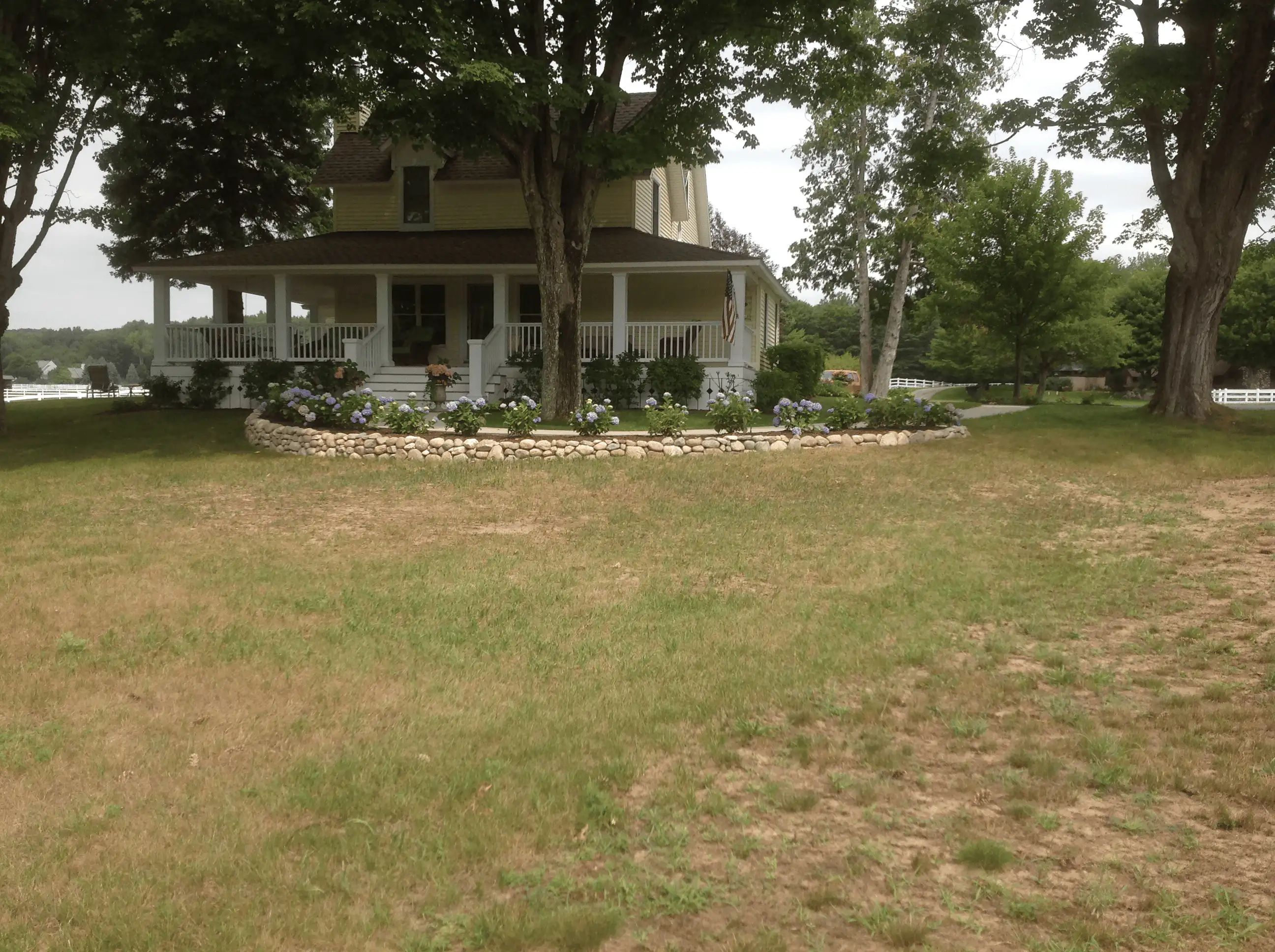 After: new boulder retaining wall with plantings integrated into the landscape.