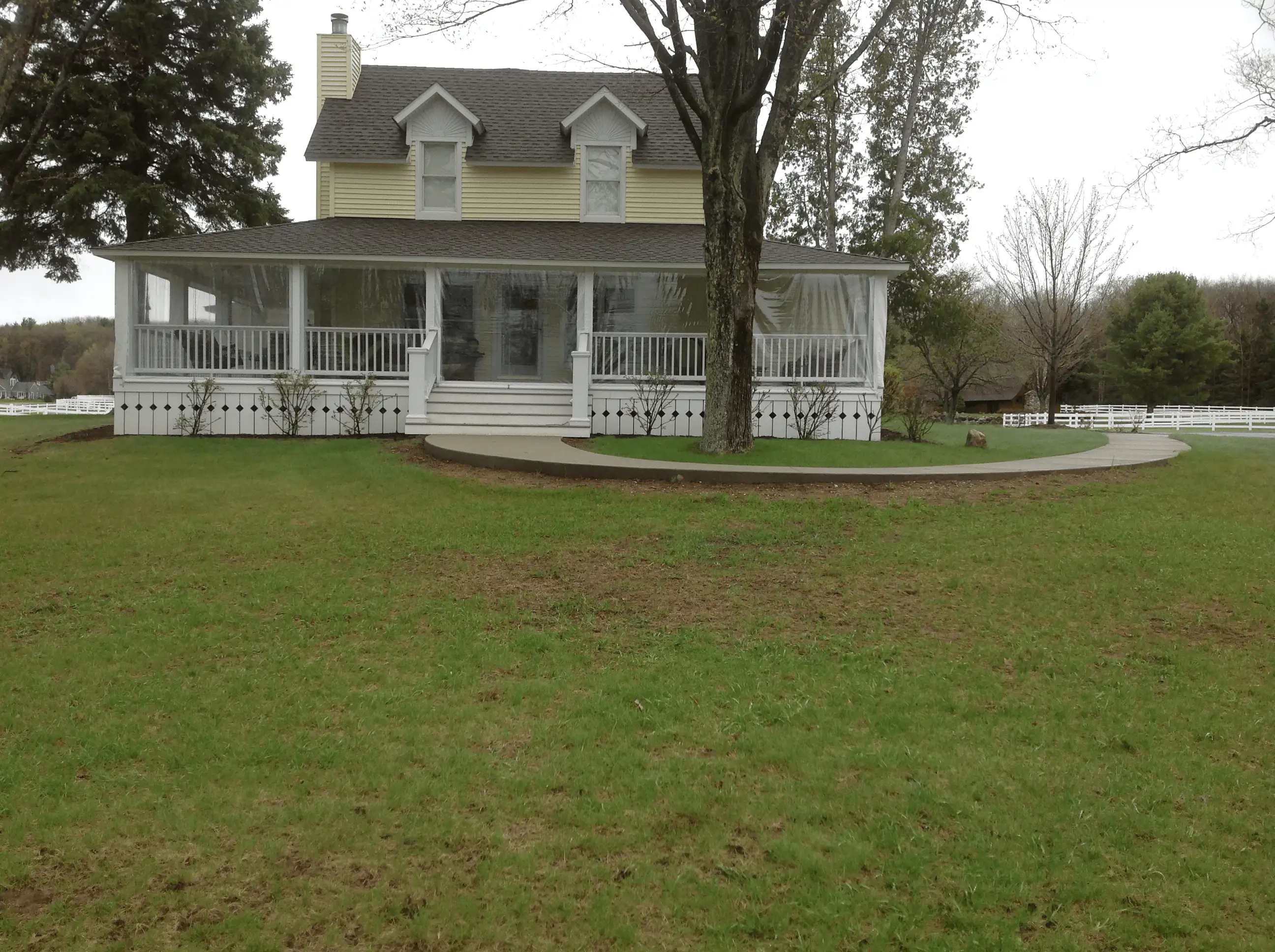 Before: slope without a retaining wall, showing erosion and grade issues.
